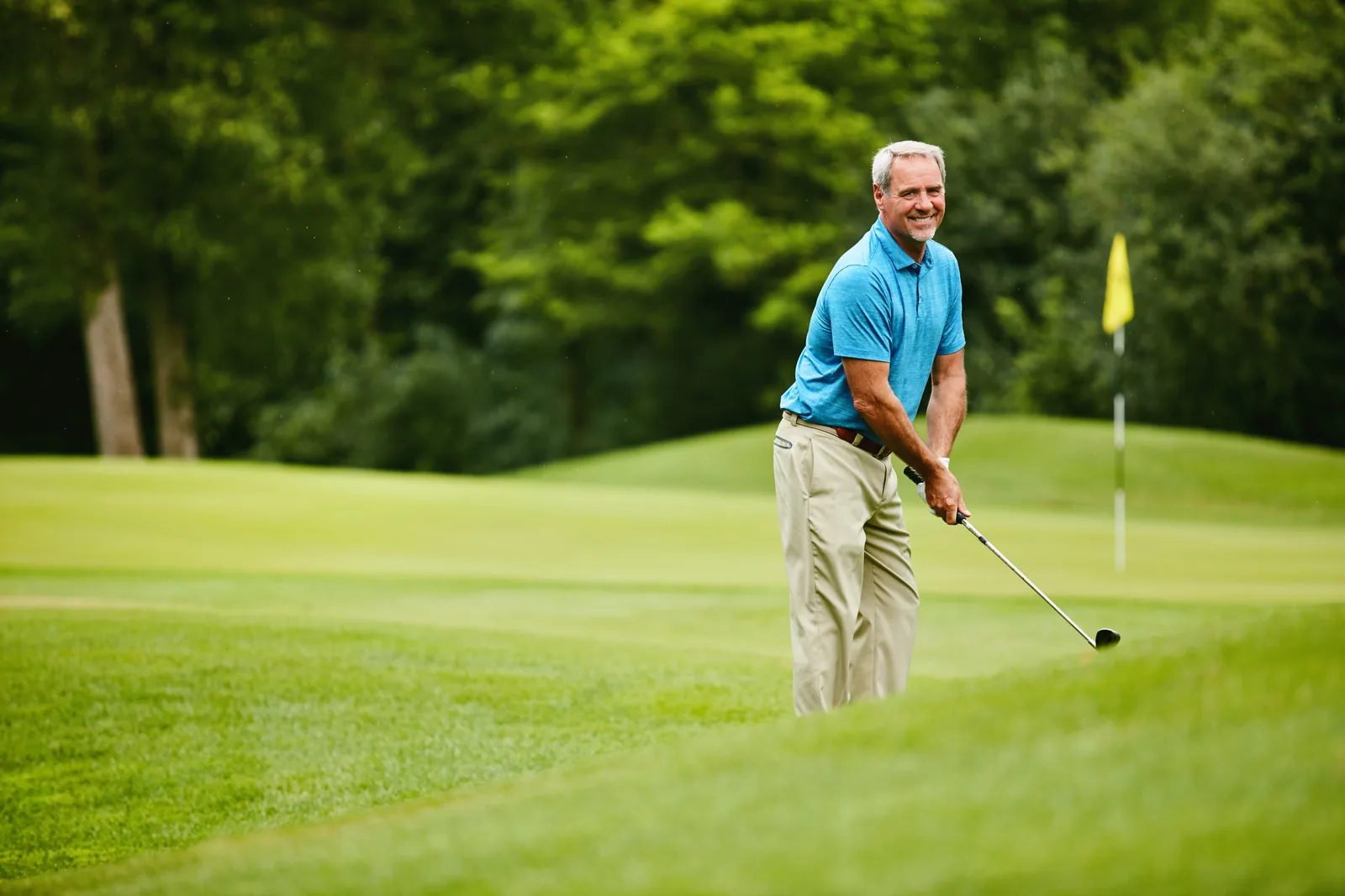 A man back out on the golf course after treatment